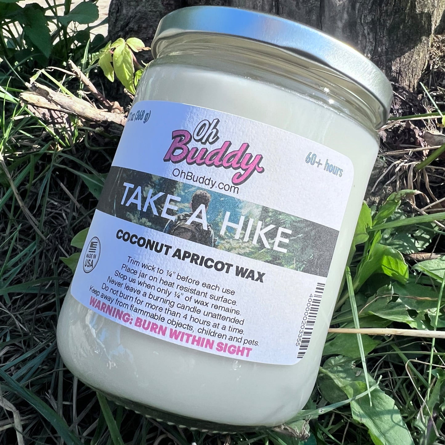 Candle jar labeled 'Oh Buddy Beanory' with coconut apricot wax on a white background